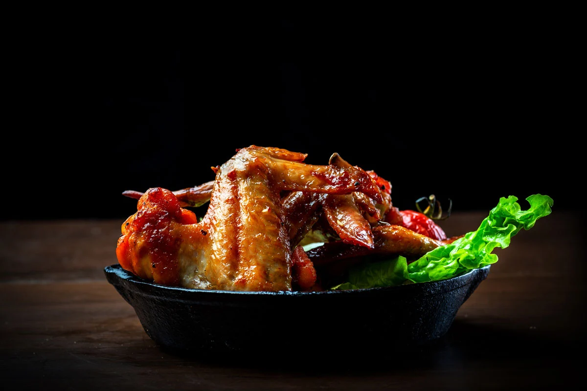 Salt and pepper chicken wings served hot in a cast iron skillet at DJ's Pizzeria & Lounge, St. Albert, AB